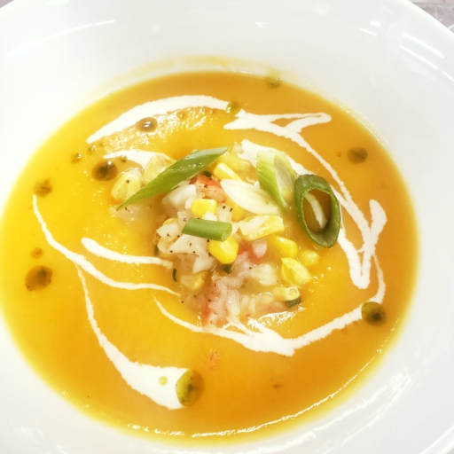 Carrot ginger soup with corn and crab